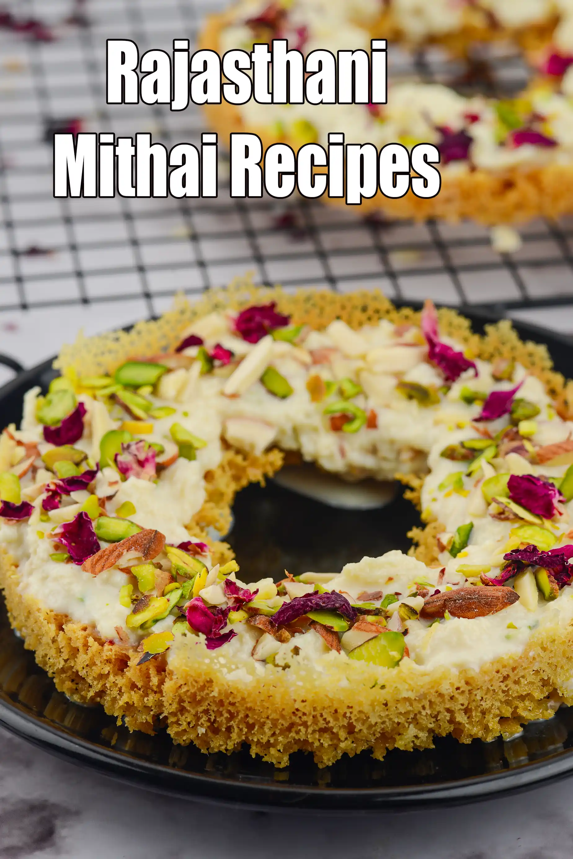 Rajasthani mithai dessert with a creamy white topping on a golden base, garnished with pistachios, almonds, and rose petals, served on a black plate, with the text “Rajasthani Mithai Recipes” displayed on the image.