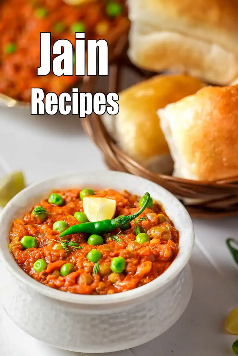 Jain pav bhaji served in a bowl with green peas, green chilli, lemon garnish and buttered pav buns on the side.
