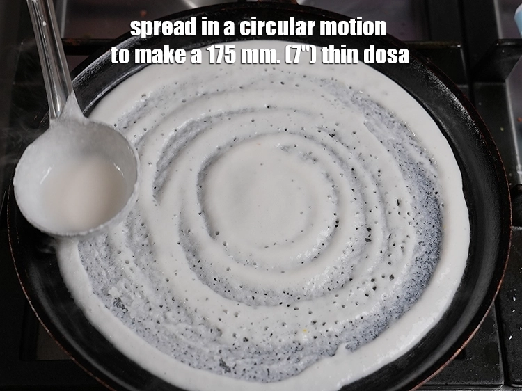 Step 23 – <p>૧૭૫ મીમી (૭") પાતળો ઢોસા બનાવવા માટે ગોળાકાર ગતિમાં ફેલાવો. Spread in a circular motion …