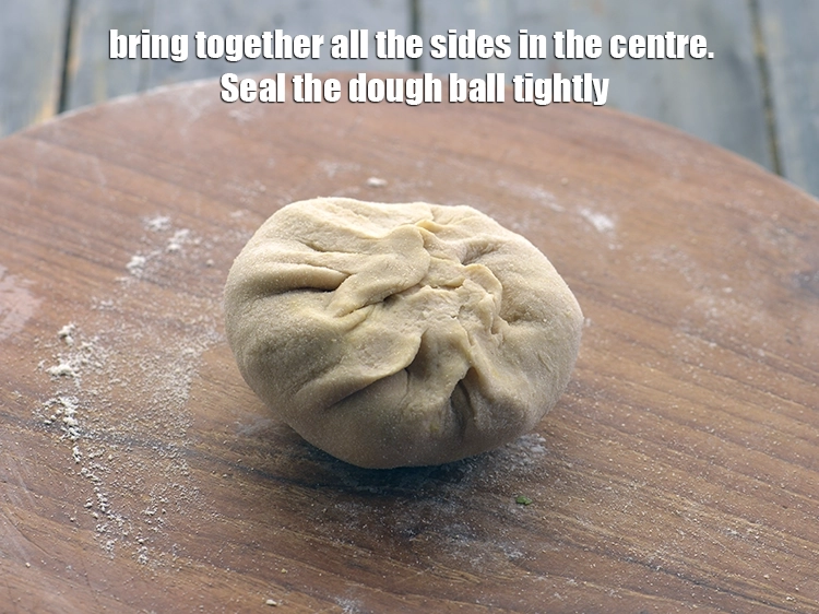 Step 23 – <p>બધી બાજુઓને વચ્ચેથી ભેગી કરો. કણકના ગોળાને ચુસ્તપણે બંધ કરો. Bring together all the sides …