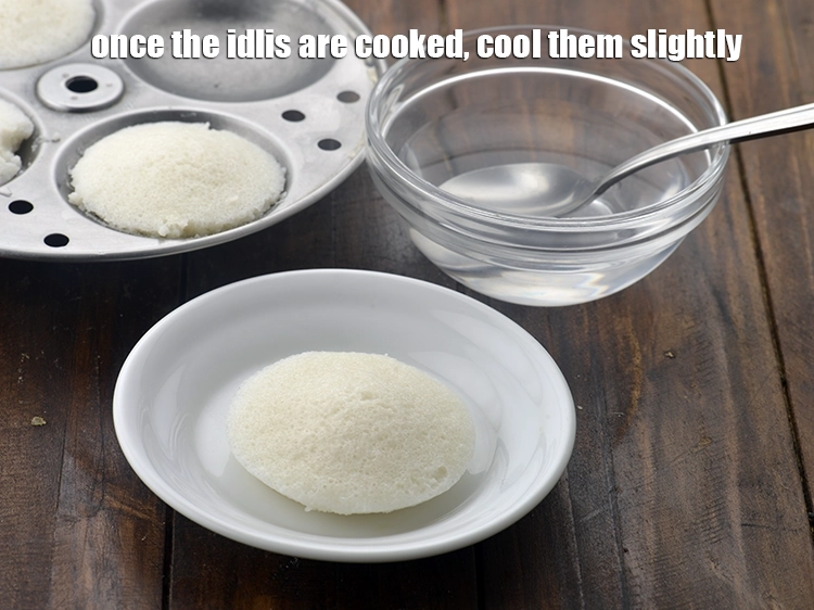 Step 7 – <p>બાફ્યા પછી, થોડી સેકન્ડ રાહ જુઓ, અને પછી ભીના ચમચીનો ઉપયોગ કરીને ઇડલીને ડિમોલ્ડ કરો. …