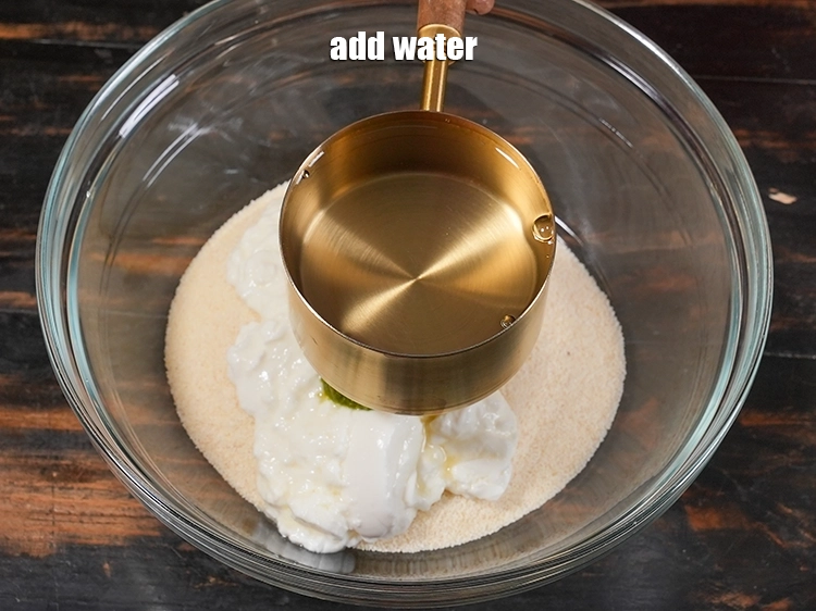 Step 5 – <p>લગભગ ૧ કપ પાણી ઉમેરો. રવાની ગુણવત્તા પ્રમાણે પાણીની માત્રા બદલાશે. Add approximately 1 cups …