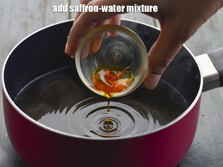 Step 12 – <p>કેસર-પાણીનું મિશ્રણ ઉમેરો. Add the saffron-water mixture.</p>