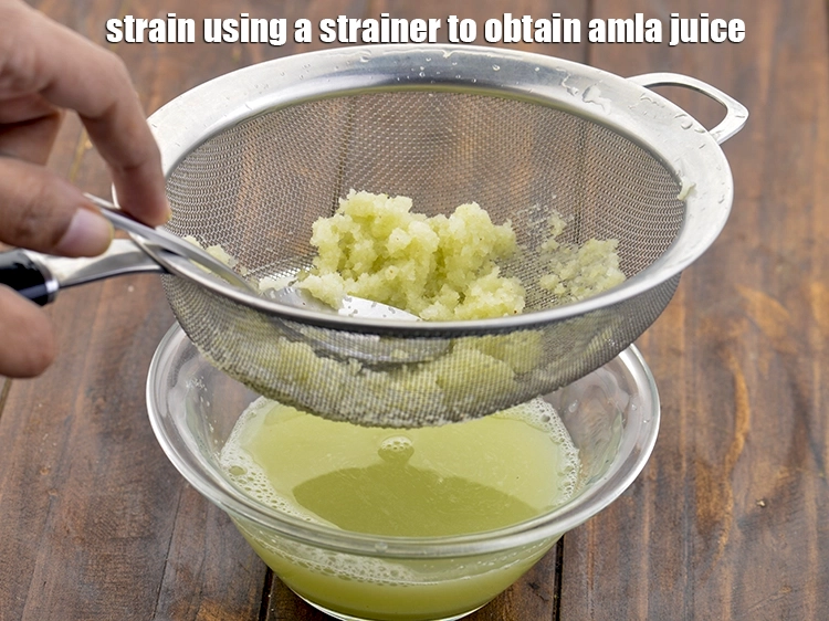 Step 15 – <p>ઘરે આમળાનો રસ મેળવવા માટે સ્ટ્રેનરનો ઉપયોગ કરીને ગાળી લો. Strain using a strainer to …