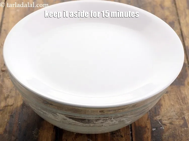 Step 8 – <p>તેને ૧૫ મિનિટ માટે બાજુ પર રાખો. આ આરામનો સમયગાળો કણકની રચનાને સુધારે છે, તેને …