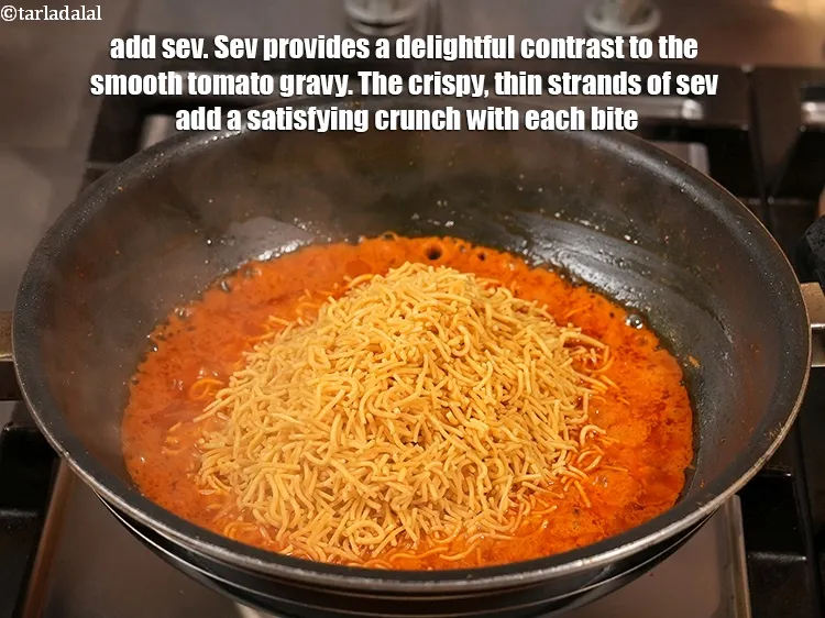 Step 20 – <p><span style="background-color:rgb(255,255,255);color:rgb(0,0,0);">1 કપ </span><a href="https://www.tarladalal.com/glossary-sev-gujarati-1137i"><u>સેવ (sev)</u></a> ઉમેરો. સેવ સ્મૂધ ટામેટાંની ગ્રેવીમાં સ્વાદિષ્ટ કોન્ટ્રાસ્ટ આપે છે. …