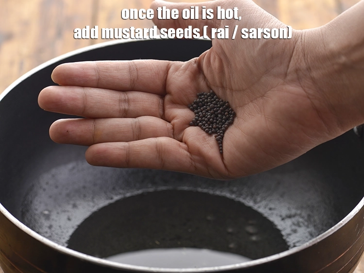 Step 21 – <p>તેલ ગરમ થઈ જાય પછી, <span style="background-color:rgb(255,255,255);color:rgb(0,0,0);">રાઈ</span> ઉમેરો.</p>