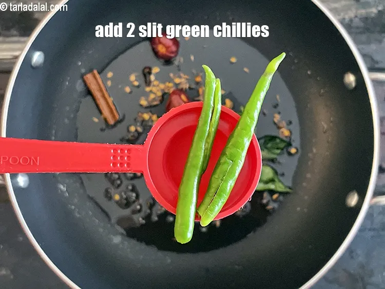 Step 21 – <p><span style="background-color:rgb(255,255,255);color:rgb(0,0,0);">2 </span><a href="https://www.tarladalal.com/glossary-slit-green-chillies-gujarati-1856i"><u>ચીરી પાડેલું લીલું મરચું (slit green chillies)</u></a> ઉમેરો.</p>