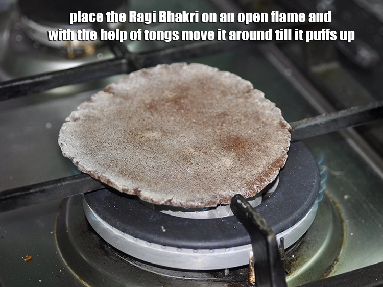 Step 13 – <p>હવે, રાગી ભાખરી ખુલ્લી આગ પર મૂકો અને ચીપિયાની મદદથી તેને ફૂલી જાય ત્યાં સુધી …