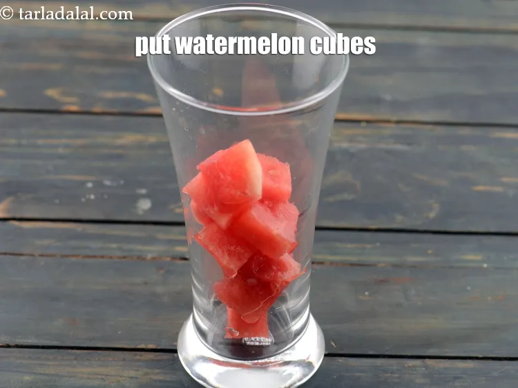 Step 2 – <p>1/2 <span style="background-color:rgb(255,255,255);color:rgb(0,0,0);">કપ </span><a href="https://www.tarladalal.com/glossary-watermelon-tarbuj-kalingar-gujarati-34i#ing_2971"><u>તરબૂચના ચોરસ ટુકડા (watermelon cubes)</u></a> નાખો.</p>