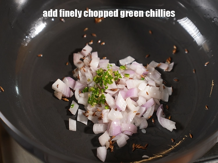 Step 13 – <p><span style="background-color:rgb(255,255,255);color:rgb(0,0,0);">1/2 ટીસ્પૂન </span><a href="https://www.tarladalal.com/glossary-green-chillies-hari-mirch-gujarati-331i#ing_2388"><u>સમારેલા લીલા મરચાં (chopped green chillies)</u></a> ઉમેરો. લીલા મરચા દાળમાં ગરમી …