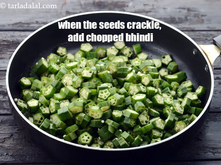Step 10 – <p>જ્યારે બીજ તતડે, ત્યારે <span style="background-color:rgb(255,255,255);color:rgb(0,0,0);">4 કપ </span><a href="https://www.tarladalal.com/glossary-ladies-finger-bhindi-okra-bhinda-lady-finger-gujarati-491i#ing_2395"><u>સમારેલા ભીંડા (chopped bhindi)</u></a> ઉમેરો.</p>