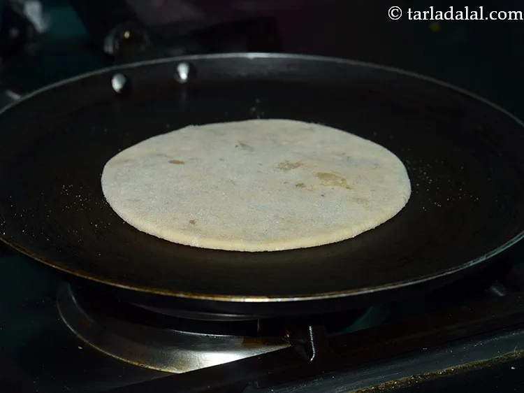 Step 23 – <p>નોન-સ્ટીક તવો (ગ્રીડલ) ગરમ કરો, તેના પર રોલ કરેલા <strong>સ્ટફ્ડ આલુ પરાઠા</strong> મૂકો.</p>