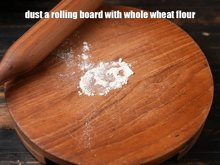 Step 12 – <p>રોલિંગ બોર્ડ પર <a href="https://www.tarladalal.com/glossary-whole-wheat-flour-gehun-ka-atta-gehun-ka-aata-gujarati-429i"><u>ઘઉંનો લોટ (whole wheat flour, gehun ka atta)</u></a> છાંટો.</p>