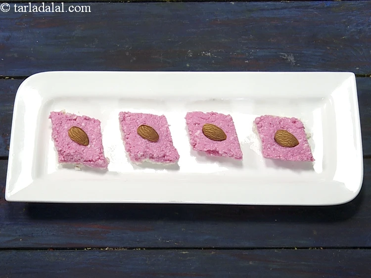 Step 19 – <p>દરેક ટુકડાને <a href="https://www.tarladalal.com/glossary-almonds-badam-gujarati-378i"><u>બદામ (almonds)</u></a>ના અડધા ભાગથી સજાવો.</p>