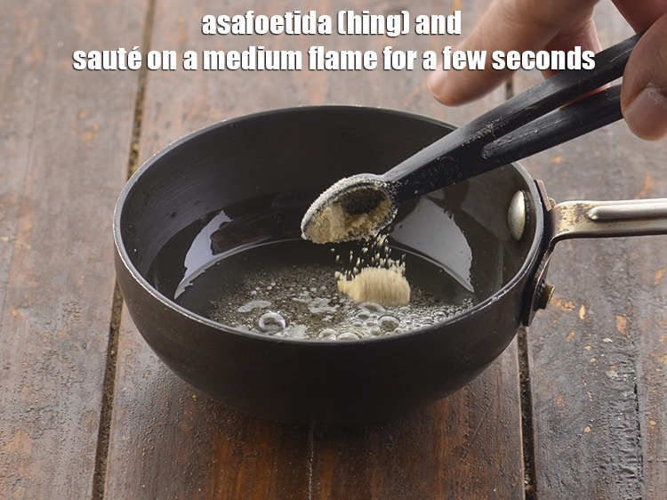 Step 7 – <p>પેનમાં <span style="background-color:rgb(255,255,255);color:rgb(0,0,0);">1/4 ટીસ્પૂન </span><a href="https://www.tarladalal.com/glossary-asafoetida-hing-gujarati-113i"><u>હીંગ (asafoetida, hing)</u></a> ઉમેરો અને મધ્યમ તાપ પર થોડી સેકંડ …