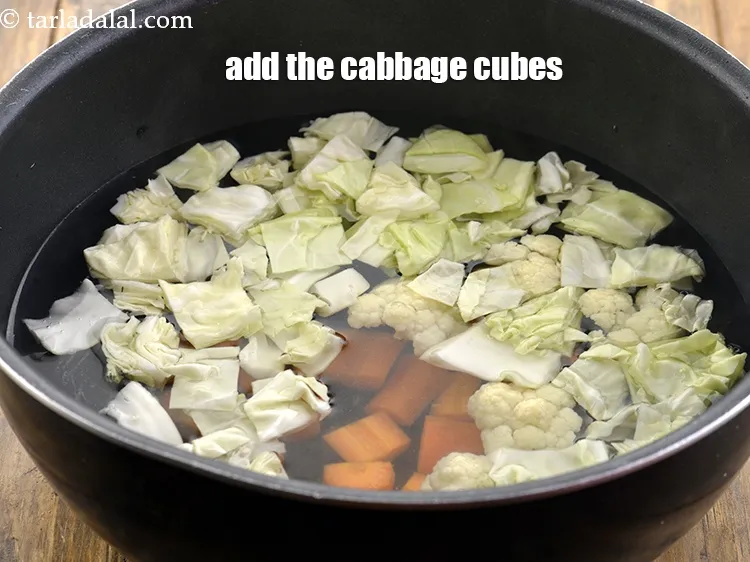 Step 6 – <p><span style="background-color:rgb(255,255,255);color:rgb(0,0,0);">1/2 કપ </span><a href="https://www.tarladalal.com/glossary-cabbage-patta-gobi-kobi-gujarati-248i#ing_2363"><u>સમારેલી કોબી (chopped cabbage)</u></a> ઉમેરો.</p>