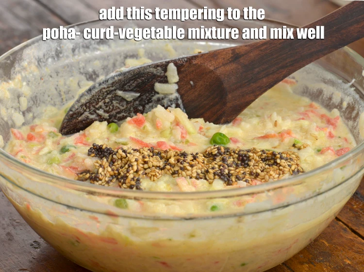 Step 35 – <p>આ વધારને પૌંઆ-દહી-શાકના મિશ્રણ પર રેડીને સારી રીતે મિક્સ કરી લો.</p>