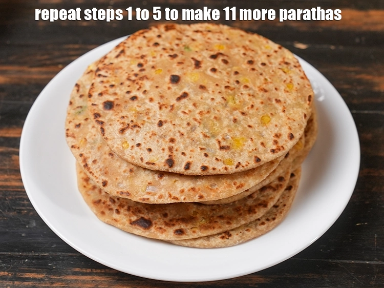 स्टेप 54 – <p>11 और <strong>पराठे</strong> बनाने के लिए चरण 1 से 5 …