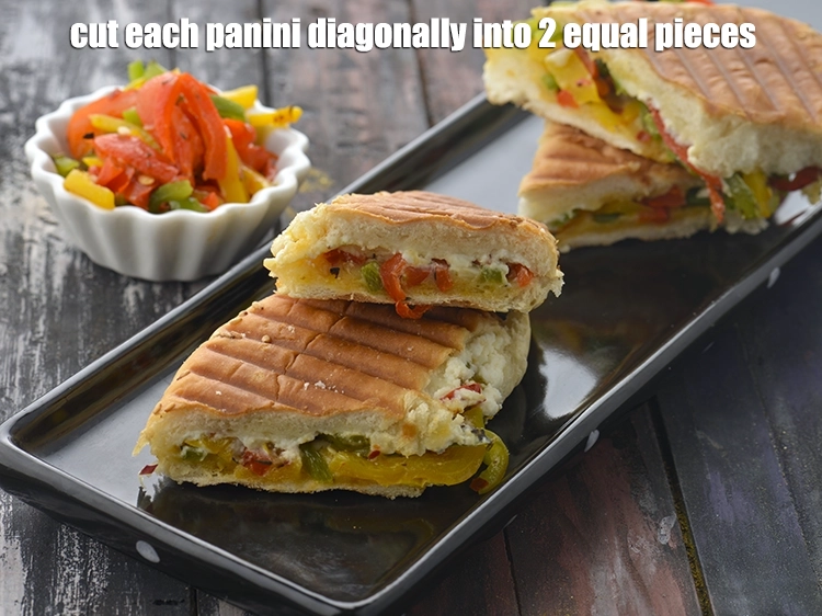 स्टेप 23 – <p>प्रत्येक <strong>पानिनी</strong> को 2 बराबर टुकड़ो में तिरछा काट लीजिए। …