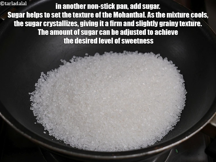 स्टेप 21 – <p>दूसरे नॉन-स्टिक पैन में&nbsp;२ कप&nbsp;<a href="">चीनी</a>&nbsp;डालें । चीनी मोहनथाल की …