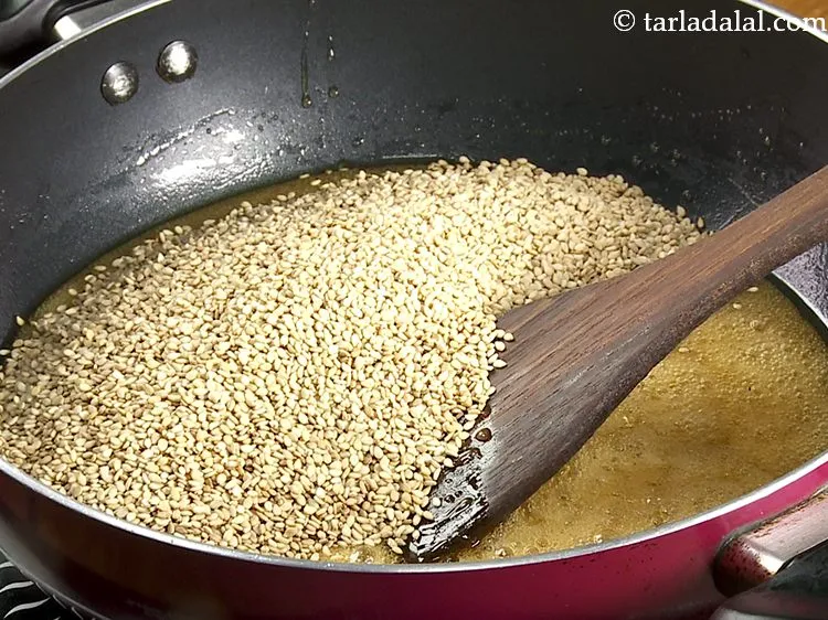 स्टेप 7 – <p><a href="https://www.tarladalal.com/glossary-sesame-seeds-til-gingelly-seeds-hindi-612i"><u>तिल (sesame seeds, til)</u></a> डालें। गुड़ और तिल हमारे …