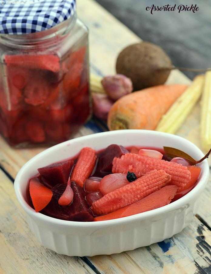 A sweetish pickle, made with a unique combination of veggies like baby corn, shallots, carrot and beetroot, this Assorted Pickle is quite versatile, and may be served as a pickle or salad, to accompany any meal. 