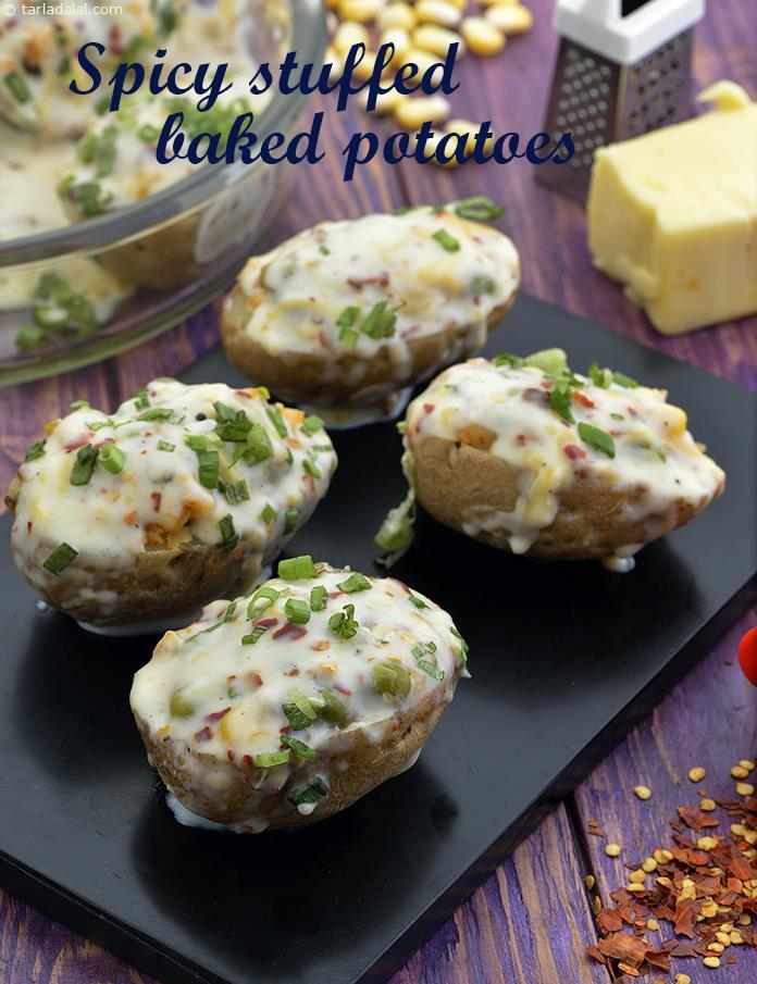 Baked Stuffed Potatoes, scopped potatoes with skin stuffed with mixed vegetables in white sauce topped with a sprinkling of cheese and microwaved.