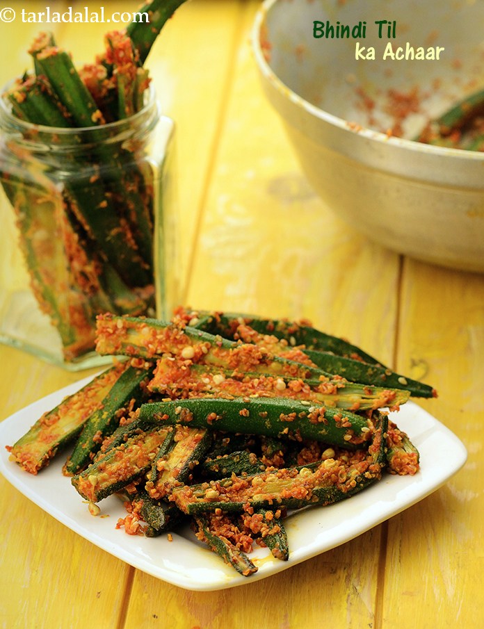 Crisp ladies fingers coated with sesame seeds along with pickling spices and mustard oil. Lemon juice added to the bhindi removes its stickiness and leaves it tart and crisp. 
