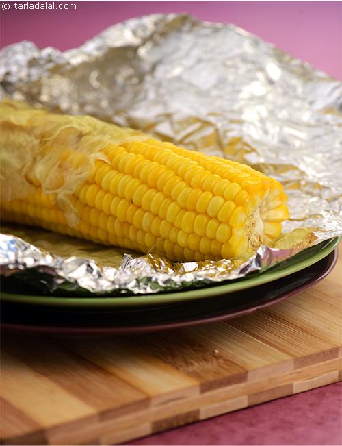 Charcoal Roast Corn, whole corn rubbed with butter and roasted, wrapped in an aluminium foil is sweet  and succulent .