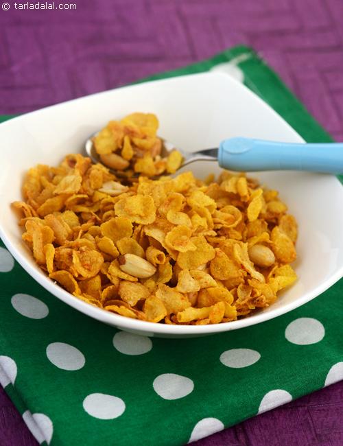 Worcestershire sauce adds a tangy twist to Cheesy Cornflakes with roasted peanuts.