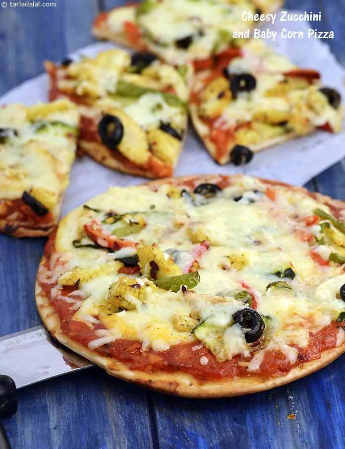 A stunning assortment of vegetables like zucchini, baby corn and capsicum combined with a luscious cheese sauce. Chunks of black olives together with a dash of herbs and spices makes the Cheesy Zucchini and Baby Corn Pizza extra special.