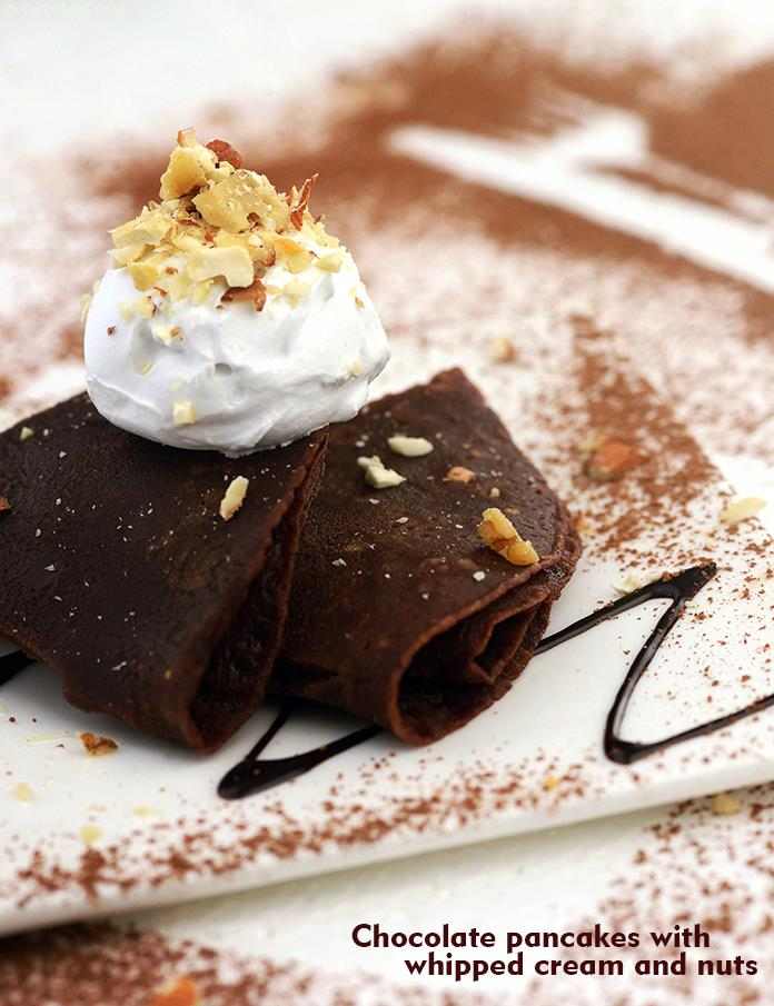 Chocolate-flavoured pancakes are arranged neatly with a topping of whipped cream and mixed nuts, so beautifully that the aesthetic presentation itself makes everybody drool. 