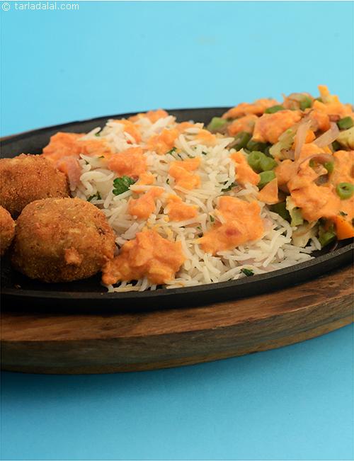 Continental Sizzler, sumptuous cheese corn balls served with buttered parsley rice, glazed vegetables topped with a red wine flavoured tomato sauce. You can serve pasta instead of the rice if you prefer.