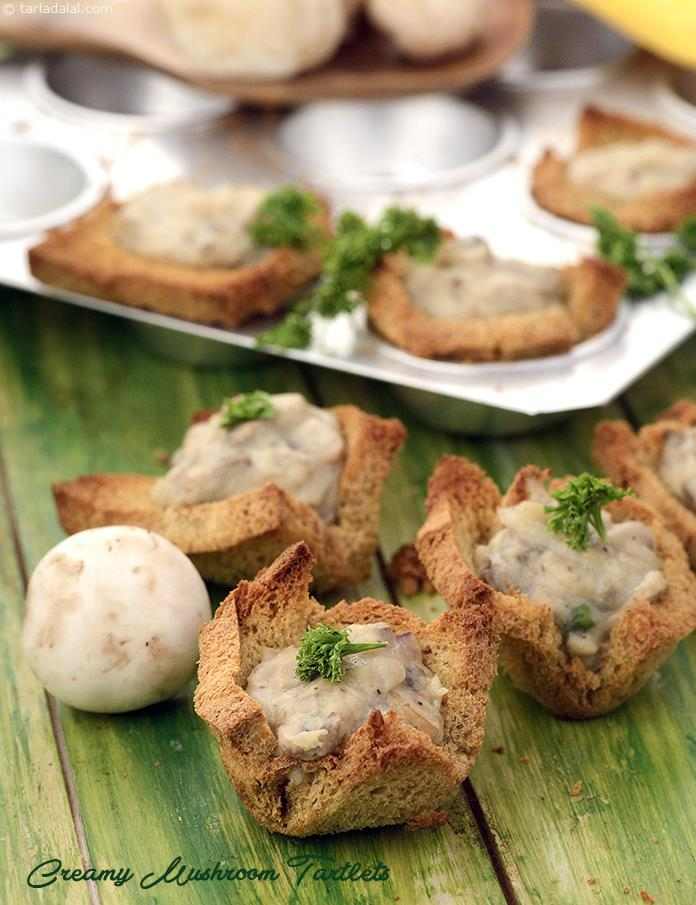 Dainty but power-packed tartlets of whole wheat bread are filled with a luscious mixture of mushrooms and onions in a creamy yet low-cal white sauce.