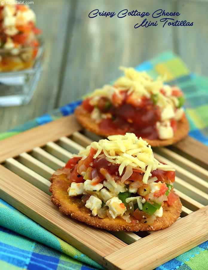 Crispy Cottage Cheese Tortillas, made from maize flour and plain flour, these crisp tortillas are topped with a mildly spiced cottage cheese, tomatoes and onions mixture.. 