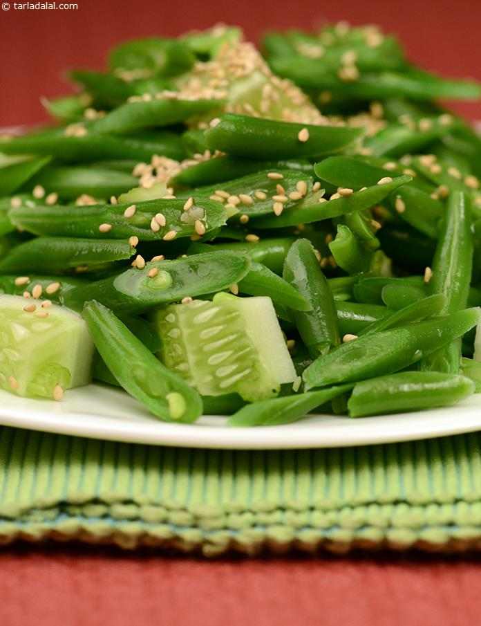French beans salad with crunchy cucumber and a tangy vinaigrette dressing topped with sesame seeds. 