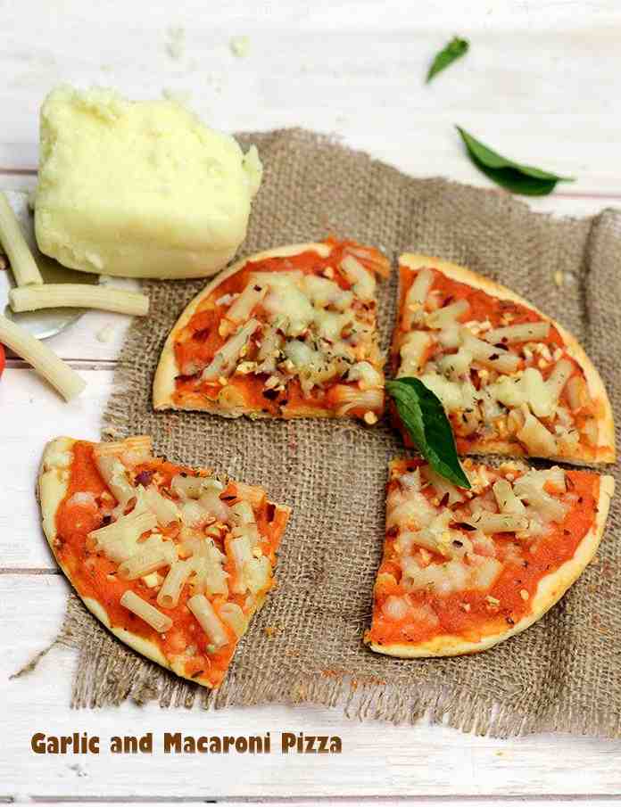 Garlic and Macaroni Pizza, a topping of herbed macaroni and garlic combined with a peppy red capsicum sauce makes this pizza really appetizing. Cooking and chopping the macaroni ensures that it blends uniformly with the other ingredients.