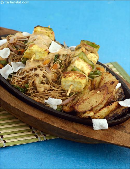Indonesian Sizzler, is laden with a bounty of flavours and spices. A delicately flavoured rice noodle preparation is topped with a smoky, curry flavoured satay, grilled and served with a spicy-sweet peanut sauce and crispy potatoes.