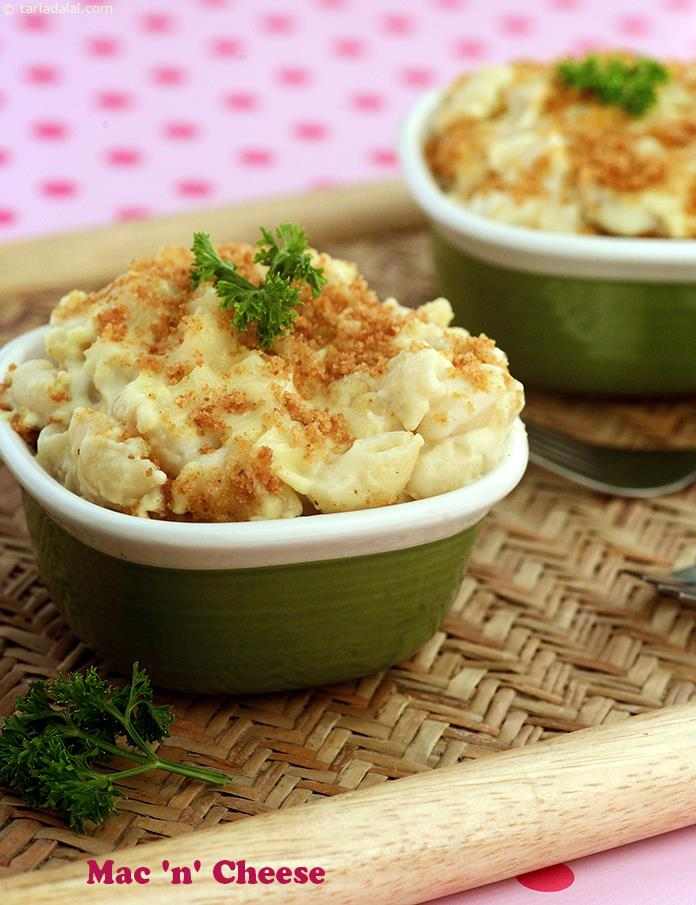 Mac N Cheese, here is a simple combination of macaroni and cheese, both of which are kiddie favourites, flavoured mildly with freshly ground pepper. A baked finish and a garnish of bread crumbs gives mac n cheese an au gratin feel.