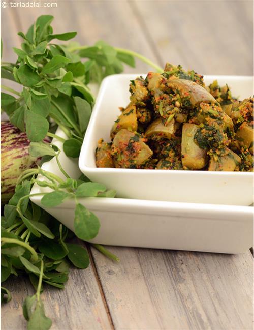 Methi Brinjal Dry Sabji, an unusual combo of brinjals and fenugreek leaves cooked with chillies, mustard seeds, khus-khus and dhania.