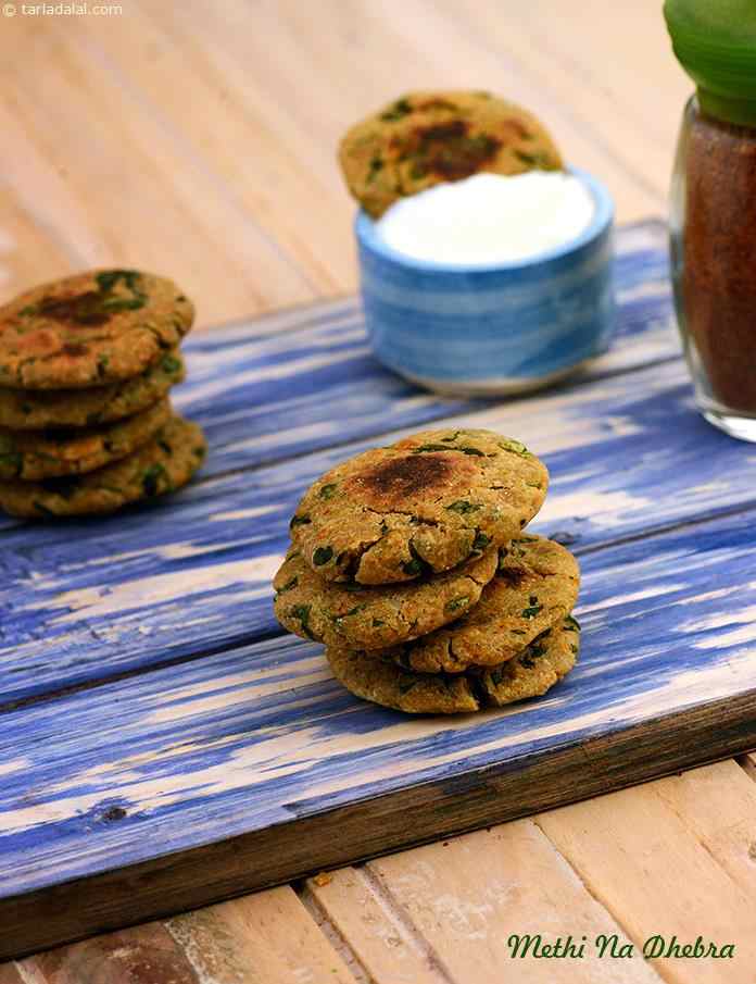 Methi Na Dhebra, an iron and fibre-rich snack made with fenugreek leaves and bajra flour, methi na dhebra is very scrumptious. Served with curds, this makes an ideal afternoon snack. 