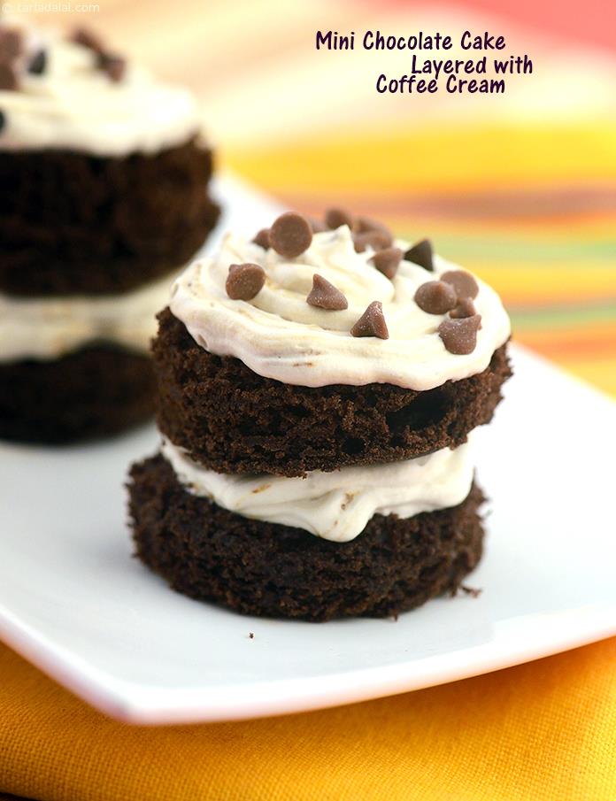 Mini Chocolate Cake Layered with Coffee Cream, bite sized chocolate sponge cakes filled with coffee cream and garnished with chocolate chips make ideal pick-me-up at tea parties.