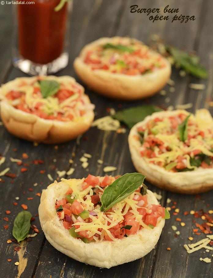 Burger Bun Open Pizza,  the buns are loaded with a colourful combo of veggies, perked up with herbs and spices, topped with cheese and cooked in the microwave for nothing more than a minute!