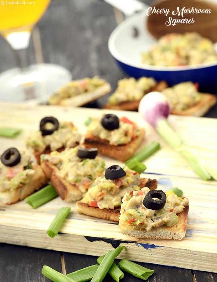 risply toasted bread slices with a creamy topping of mushrooms cooked with crunchy capsicum, spring onions, celery and cheese, the Cheesy Mushroom Squares are a perfect snack to serve at garden parties.