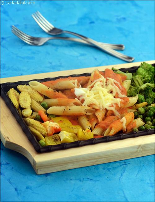 Noodle and Vegetable Sizzler, a tasteful combination of sizzling vegetables and pasta, drowned in a tangy tomato sauce.