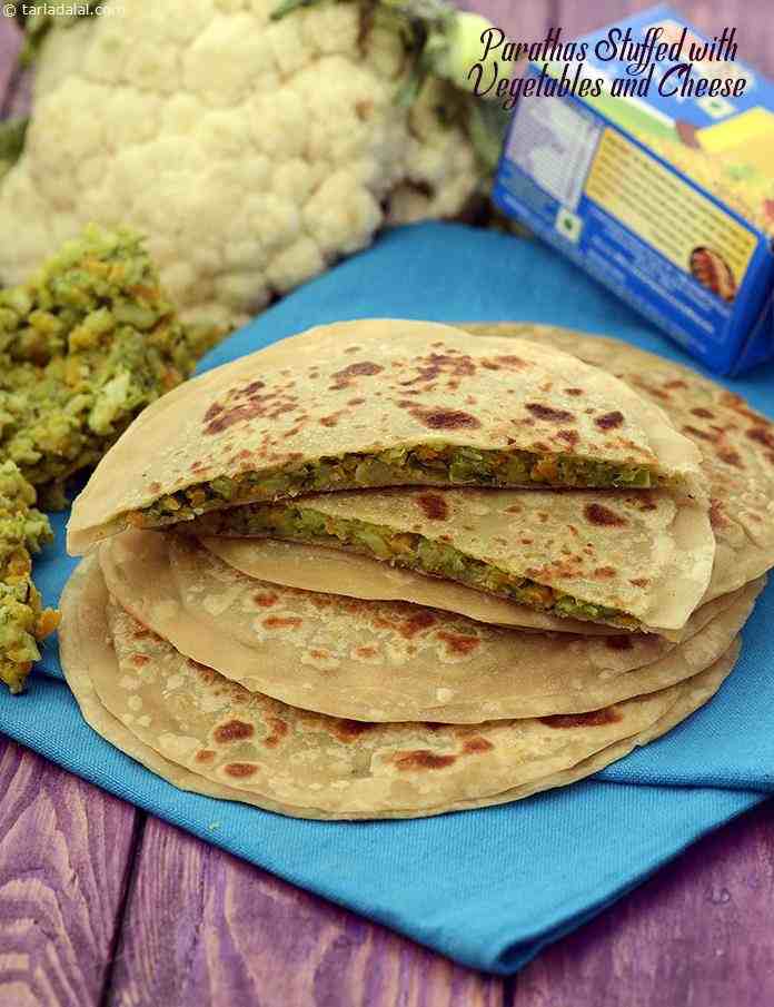 Parathas Stuffed with Vegetables and Cheese, assorted veggies, finely chopped, are sautéed with a tempering of jeera and mixed with cheese to make a mouth-watering stuffing for these parathas.