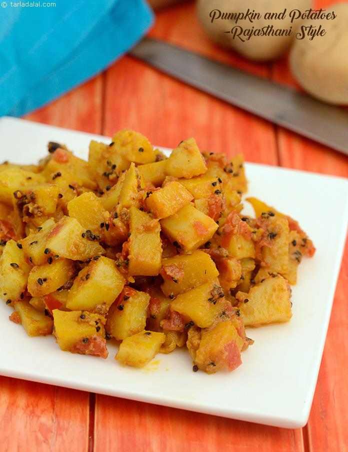 Pumpkin and Potatoes- Rajasthani Style, curds, tomatoes and dried mango powder impart the required tang to the potatoes and red pumpkin cubes, while spice powders like coriander-cumin powder and chilli powder add to the aroma and spice.