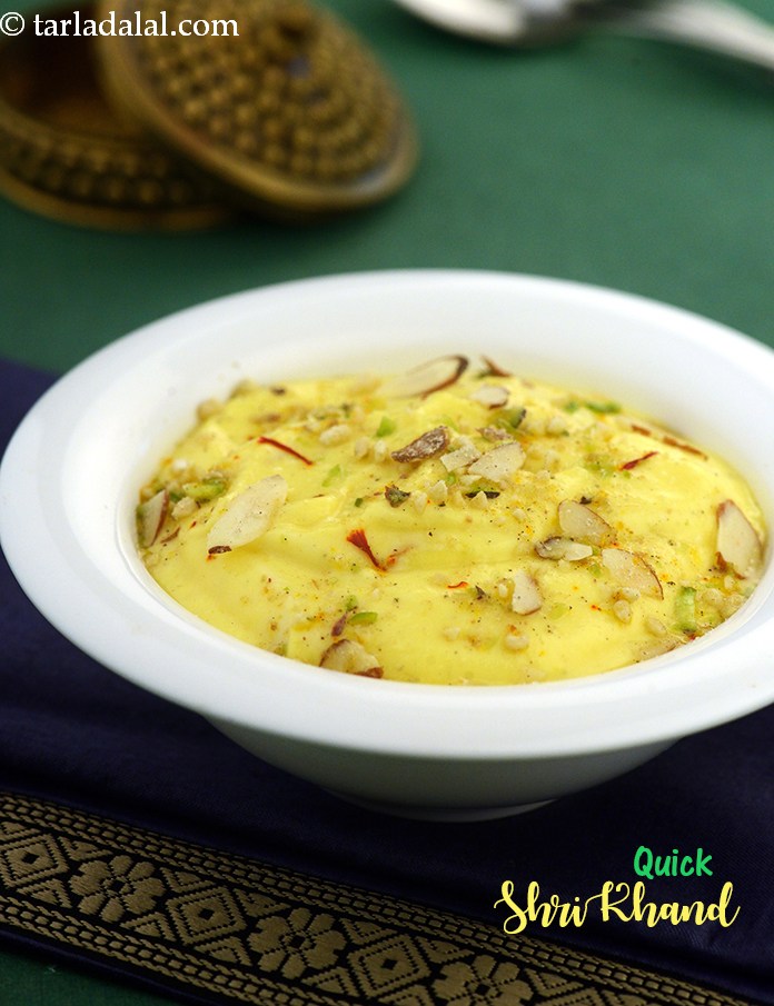 Quick Shrikhand, a dollop of gooey, creamy shrikhand laced with saffron and elaichi, topped with mixed nuts, and served with steaming hot puris.