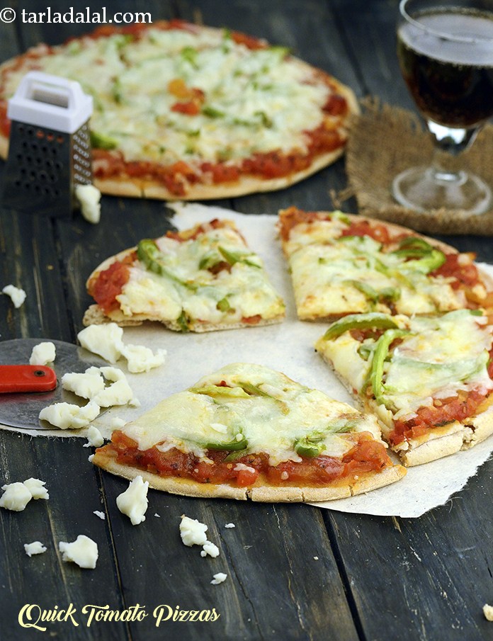 Whip up some thick, fresh tomato pizza sauce and spoon them on to the pizza base. Top up with capsicum, onions and lots of cheese and bake until the cheese is all molten and hot! bite into a slice of this pizza and enjoy!